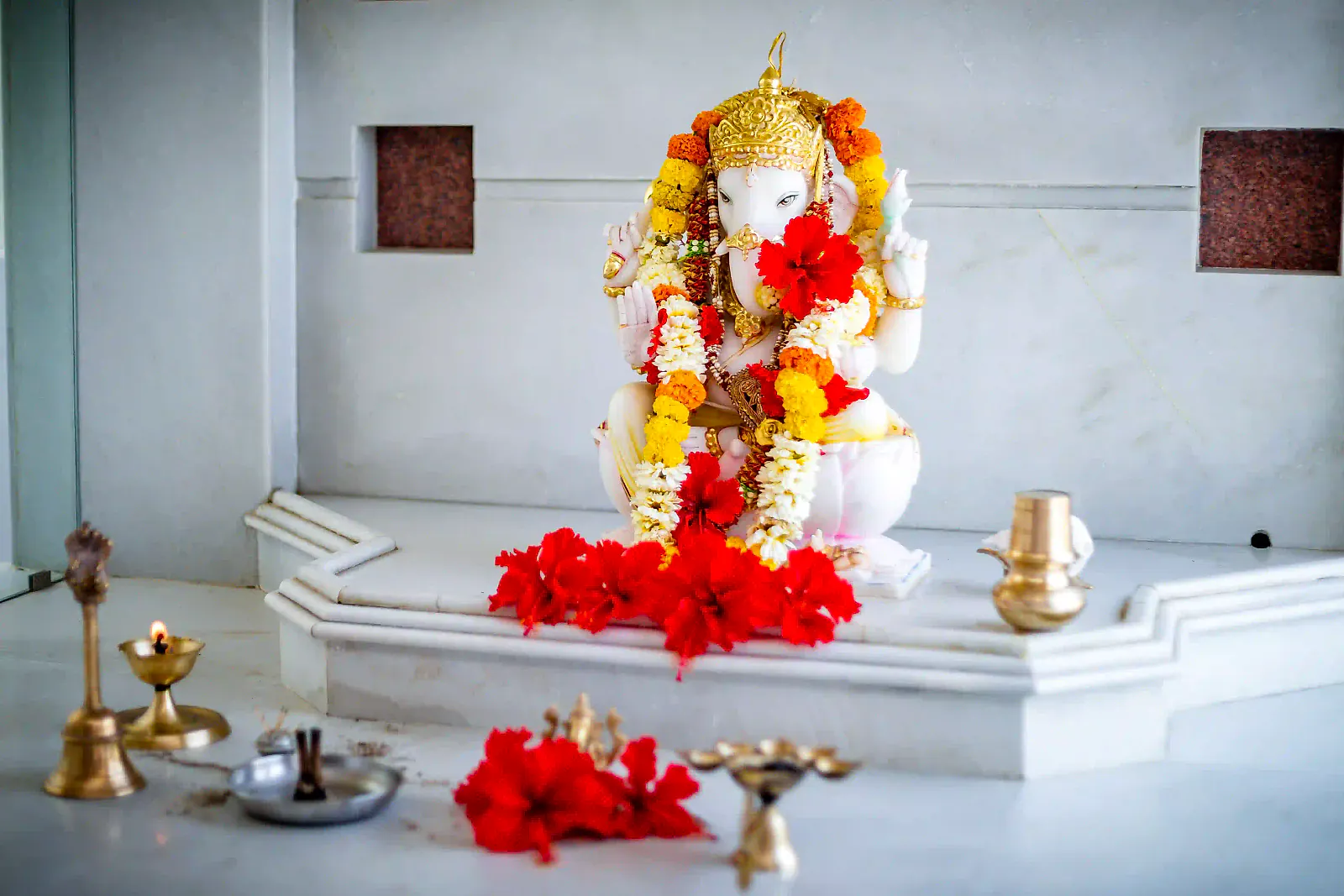 The Ganesha idol in the on-site temple, decorated with flowers