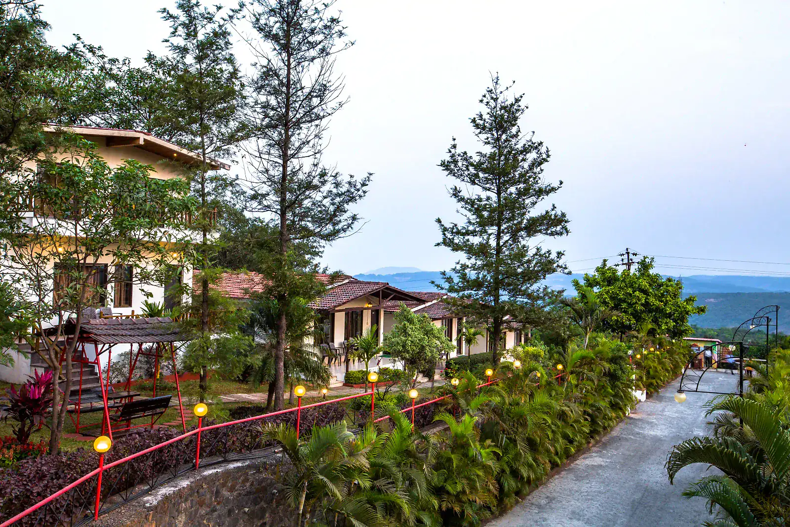 Wide view across Cloud 9 Hills Resort towards the Sahyadri ridges