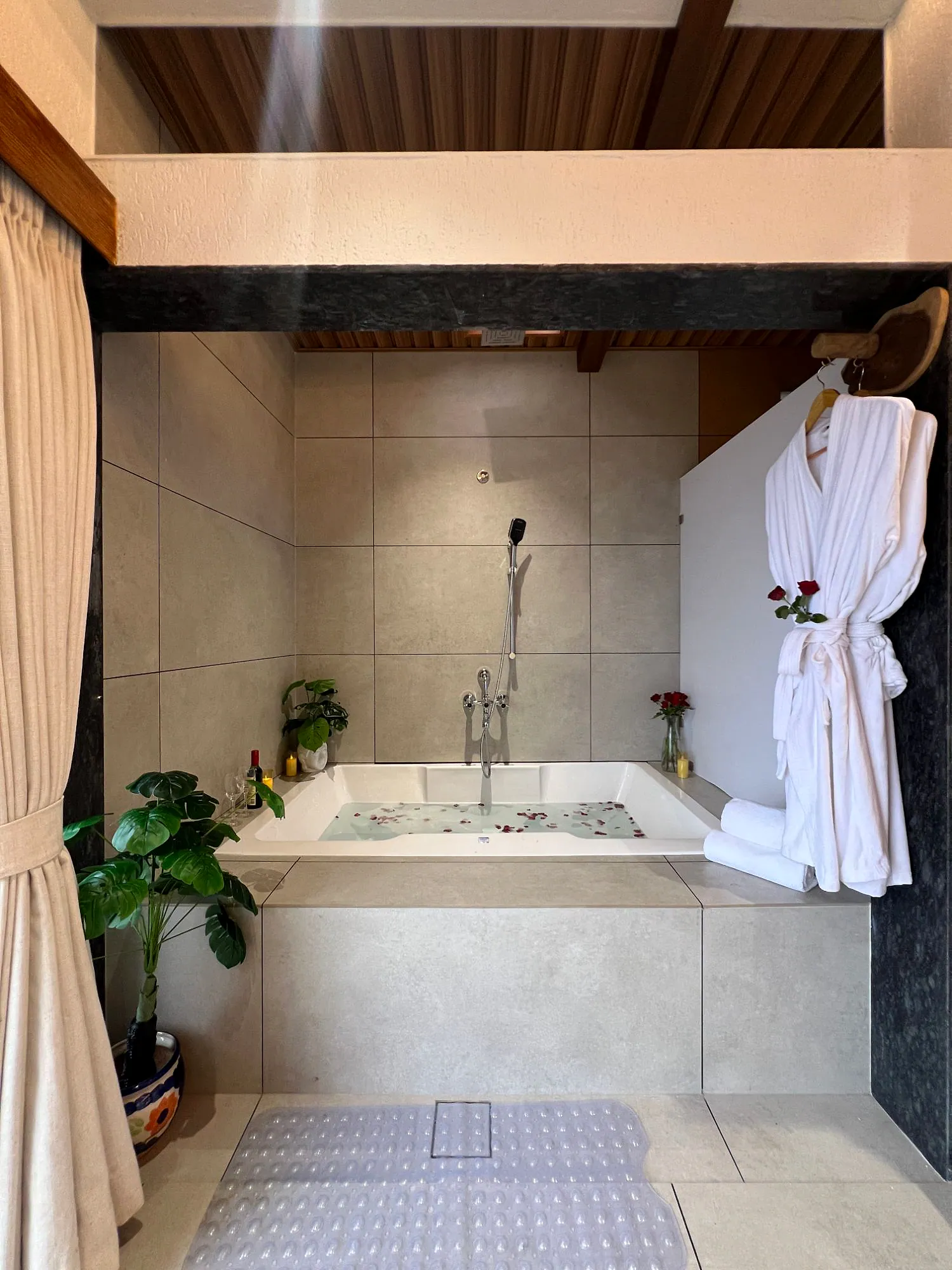 Premium Suite bath area with bathtub and robe