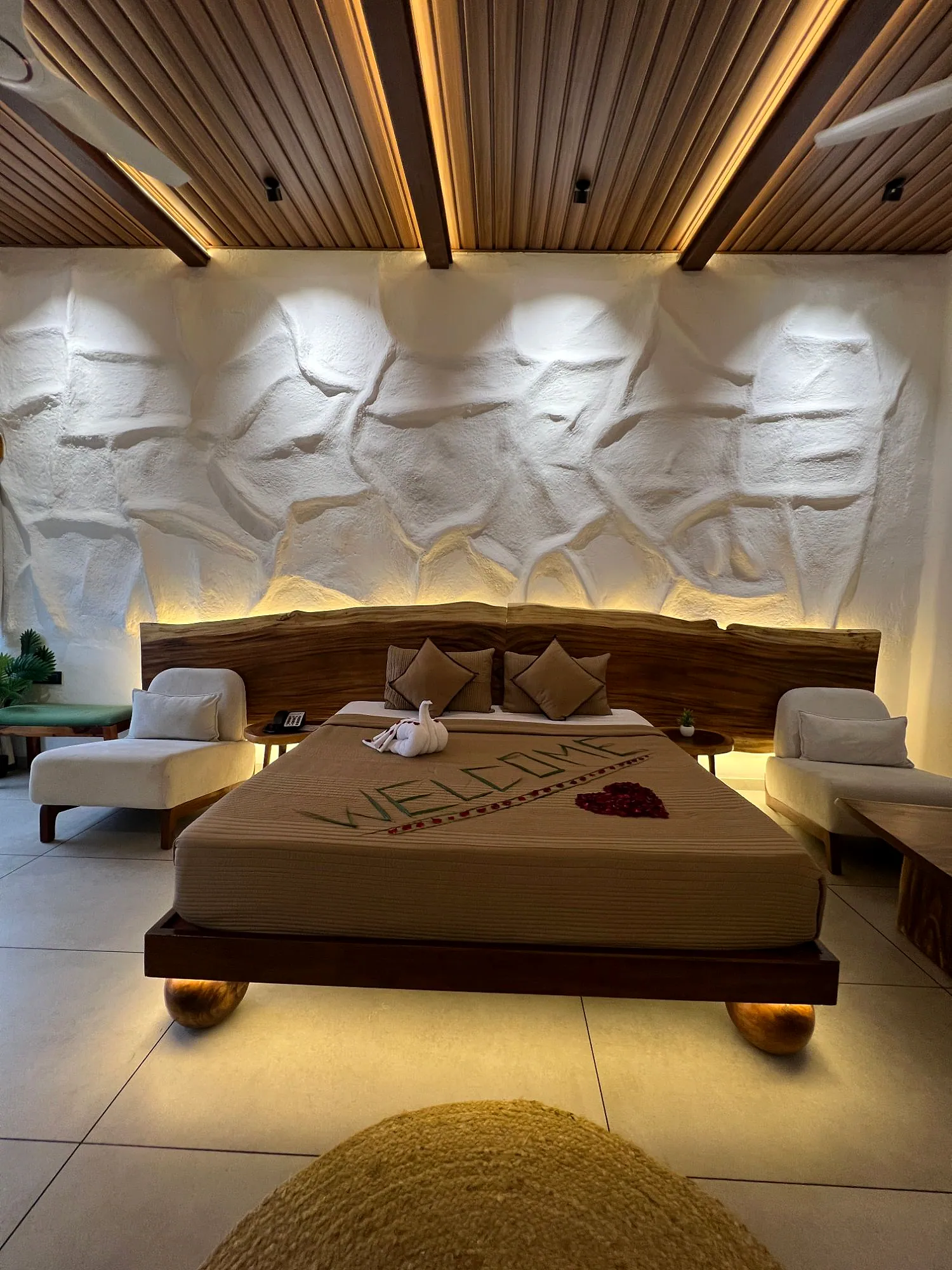 Premium Suite bed with welcome decoration and sculpted feature wall