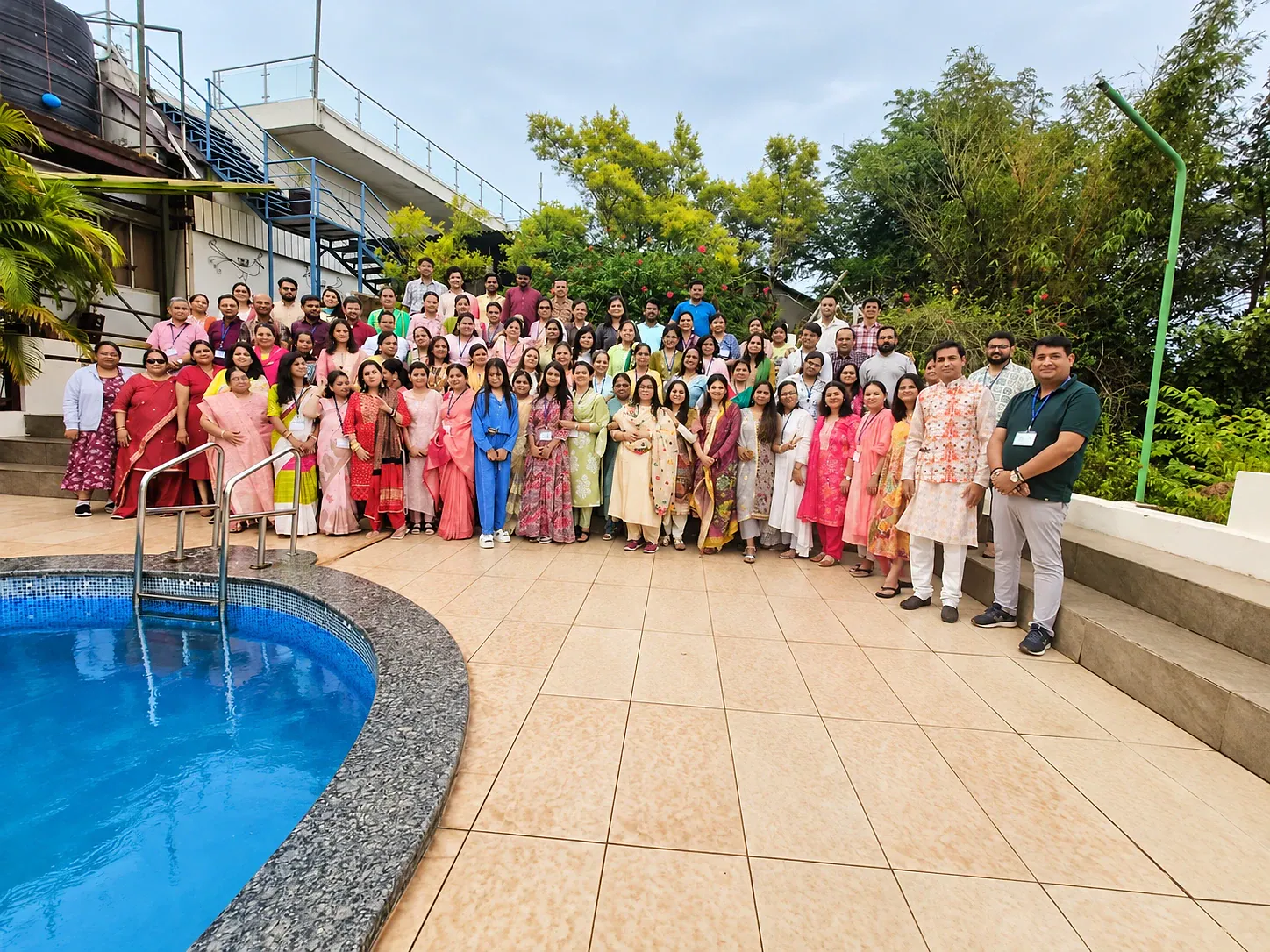 A retreat group gathered by the pool at Cloud 9